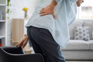 Man clutching painful lower back